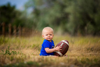 Football themed 1 year old boys outdoor portrait