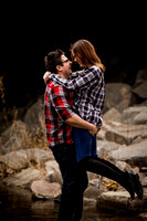 man picks up woman in a couples photoshoot while in a colorado stream