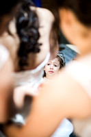 Bride's daughter watching her get her wedding dress on