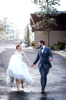 Bride and groom running in the parking lot to take photos