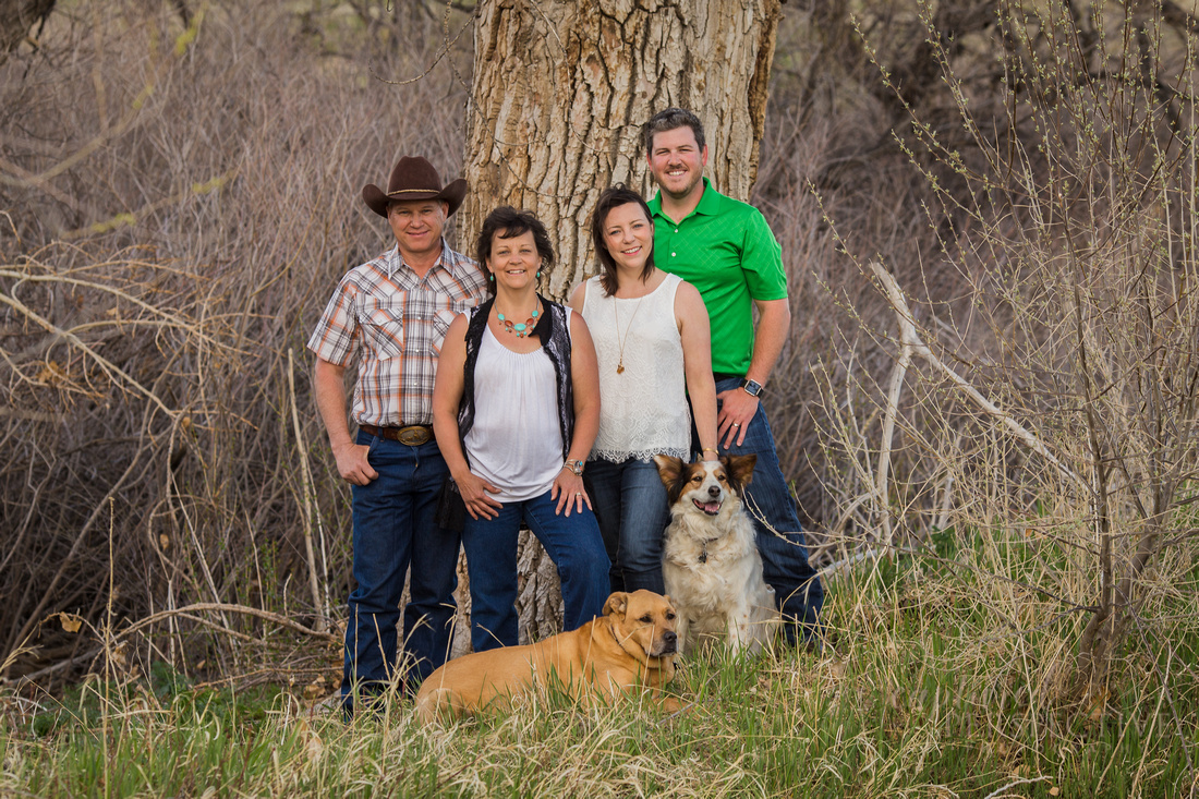 Outdoor family  portrait with their two dogs